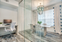 Resident business meeting area with table, chairs, and glass chandelier