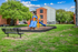 Colorful playground with bench and apartment exterior