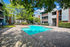Pool with sundeck surrounded by trees
