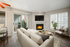 Sectional white couch, ceiling fan, wall-length glass patio door