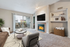 Living room with fireplace, flat TV, glass table, gray chair