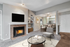 Living room with fireplace, flat TV, glass table, gray chair