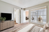 Carpeted bedroom with king size bed and flat screen TV, large window