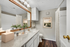 Bathrrom with granite counters and hard-wood floors with vanity lighting
