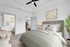 Bed with ceiling fan, side table and wall art