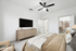 Bed, TV, dresser, and ceiling fan