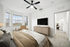 Bed, dresser, TV, and window