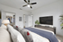 Bed, TV, and ceiling fan