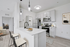 Kitchen with vinyl floors, stainless-steel appliances, white quartz countertop, and pendant lighting