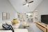 Carpeted living room with ceiling fan, couch
