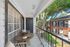 Balcony with wooden furniture looking over greenery