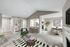 Carpeted living room with chair and glass table