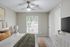 Carpeted bedroom with large window and lamp