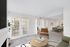 Carped living space with large window, chair and table