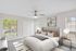 Virtual staging of bedroom with large bed and ceiling fan