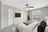 Virtual staging of bedroom with large bed and ceiling fan