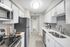 White quartz counters, stainless-steel appliances, white cabinetry