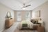 Carpeted bedroom with ceiling fan and large window