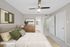 Virtual staging of bedroom with large bed and ceiling fan