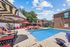 swimming pool with sundeck surrounded by apartment buildings