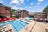 Swimming pool with sundeck surrounded by apartment buildings
