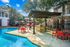 outdoor kitchen with grills next to swimming pool