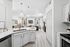Vinyl floors, stainless-steel appliances, white quartz countertop, and pendant lighting.