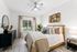Carpeted bedroom with ceiling fan, bed, and window