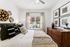 Carpeted bedroom with ceiling fan, bed, and window