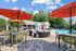 Halston South Point Pool Lounge Area With Chairs Umbrellas Furnished Lounge and Pool Feature In Background