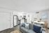 Bright and inviting modern apartment interior featuring a sleek stainless steel kitchen, cozy living area with stylish blue accents, and an elegant dining space perfect for entertaining.