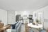 Chic open-concept apartment with modern kitchen featuring stainless steel appliances, cozy living area, and stylish dining space.