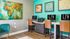 Vibrant co-working space at LIV at Winter Park, featuring modern workstations, colorful artwork, and comfortable seating for productivity and creativity.