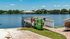 Picturesque waterfront view with a charming lakeside gazebo and kayak rentals, perfect for outdoor enthusiasts.
