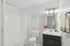Bright modern bathroom with elegant lighting, a spacious tub, and contemporary fixtures creating a serene oasis.