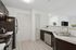 Modern kitchen with sleek stainless steel appliances, elegant dark cabinetry, and a stylish marble countertop, perfect for culinary enthusiasts.