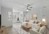 Bright and modern living room featuring a plush sectional sofa, cozy accents, and large windows with natural light.