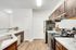 Modern kitchen with sleek appliances, rich wooden cabinetry, and pristine marble countertops offering a luxurious cooking experience.