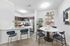 Elegant open-plan dining area with modern kitchen, chic decor, and breakfast bar seating. Perfect for entertaining.