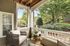 Charming patio with cozy seating offers a serene view of lush greenery, ideal for relaxation and outdoor enjoyment.