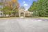 Leasing Office entrance with elegant architecture, surrounded by lush greenery and vibrant autumn foliage.