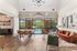 Clubhouse featuring modern furnishings, expansive windows overlooking a scenic pool, and elegant decor for a luxurious atmosphere.