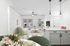 Bright and inviting living space with modern furniture, open floor plan, and stylish kitchen island featuring pendant lighting.