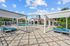 Inviting outdoor communal space with swimming pool, pergolas, and comfortable lounge seating, perfect for relaxation and social gatherings.