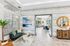 Clubhouse featuring a stylish lounge area with elegant furniture, large windows, and modern decor leading into a spacious community room.