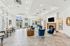 Clubhouse with blue chairs, a cozy fireplace, and abundant natural light, perfect for relaxing and entertaining.