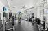 Modern fitness center with state-of-the-art equipment, sleek design, and ample natural light for an invigorating workout experience.