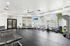 Modern fitness center with state-of-the-art equipment, bright windows, and sleek design, ideal for energetic workouts.