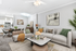 Elegant modern living room featuring cozy seating, tasteful decor, and an open kitchen dining area with chic lighting.