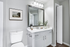 Elegantly designed bathroom featuring a sleek vanity with a large mirror, modern lighting, and artistic wall decor.